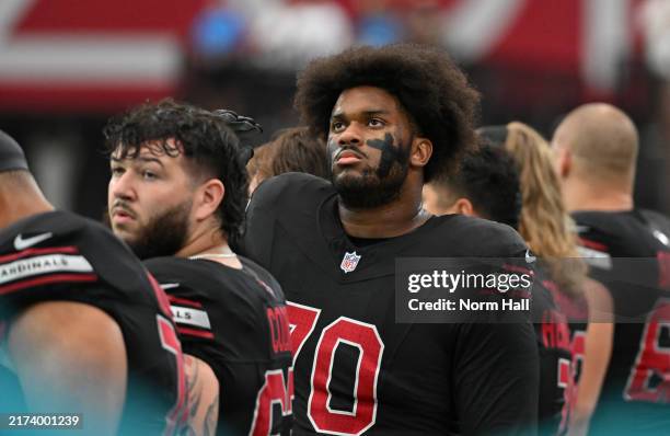 Paris Johnson Jr of the Arizona Cardinals stands for the national anthem prior to a game against the Detroit Lions at State Farm Stadium on September...