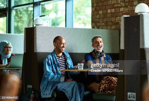 cheerful business colleagues smiling and laughing in meeting - lgbtqia people stock pictures, royalty-free photos & images