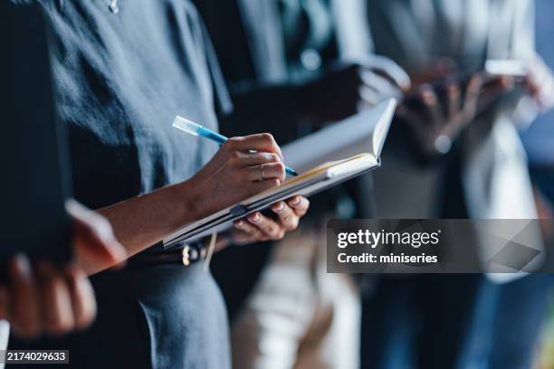 collaborative business meeting with focus on note taking - agenda pessoal imagens e fotografias de stock