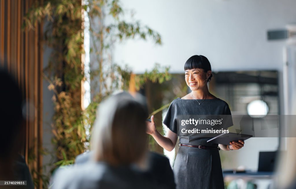Confident Businesswoman Leading a Team Meeting with a Smile