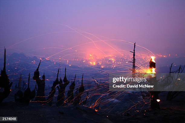 Strong wind blows embers from a burning tree trunk in Lost Valley as the Coyote Fire burns more than 11,000 acres of chaparral and forest on the...