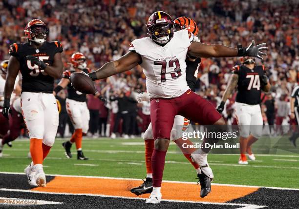 Trent Scott of the Washington Commanders celebrates after scoring a touchdown against the Cincinnati Bengals during the third quarter at Paycor...