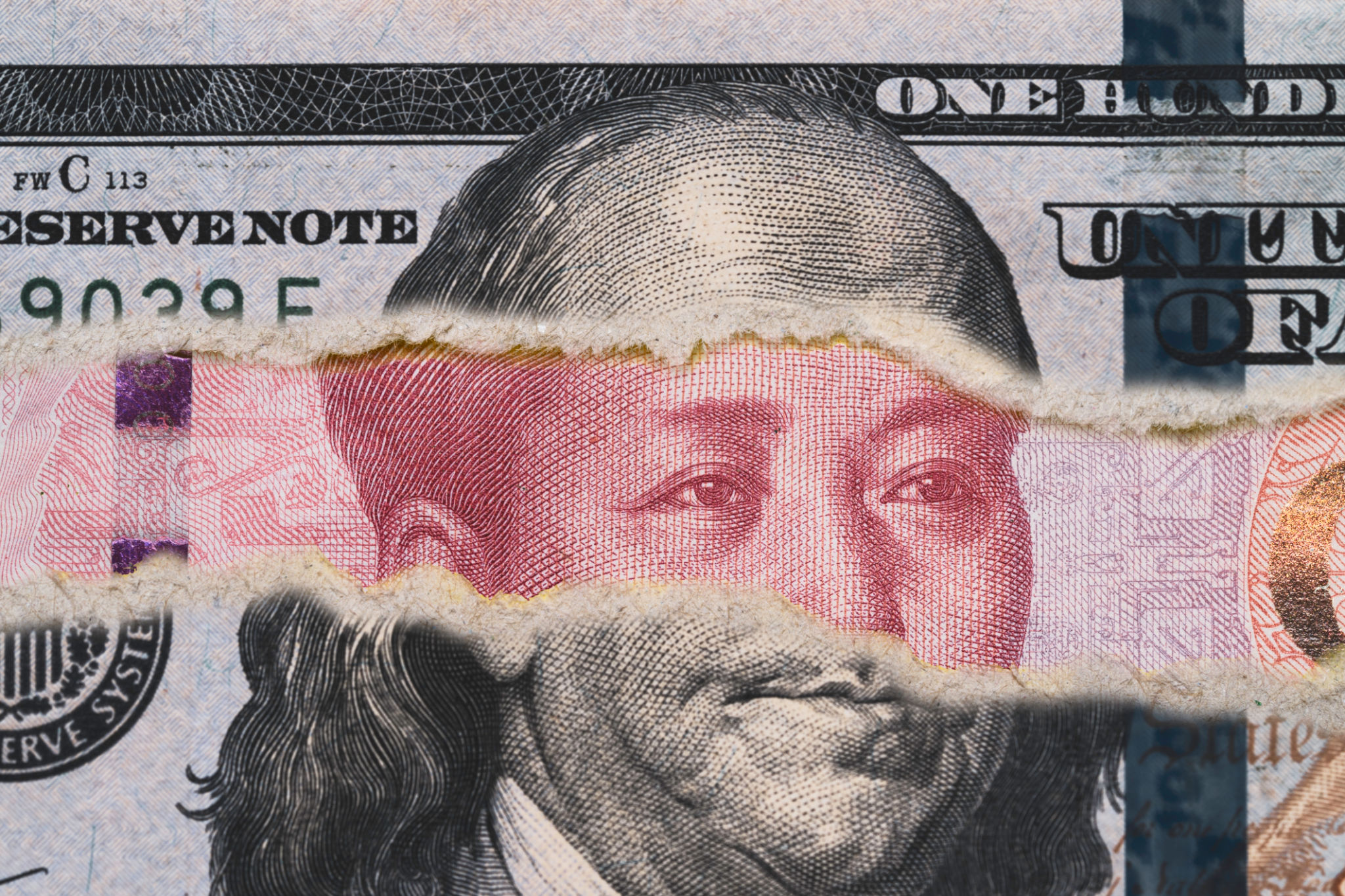 Benjamin Franklin on USD dollar banknote tear with Mao Tse Tung on Yuan banknote for competitive countries both business and military concept. Benjamin Franklin on USD dollar banknote tear with Mao Tse Tung on Yuan banknote for competitive countries both business and military concept.