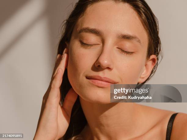 close-up portrait of a woman with clean, moist skin in the sunlight - ren bildbanksfoton och bilder