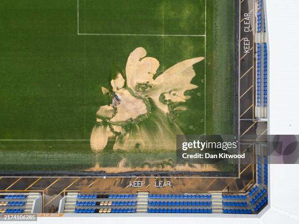 An aerial view shows a sinkhole that has appeared on the AFC Wimbledon football pitch after heavy rain on September 24, 2024 in London, United...