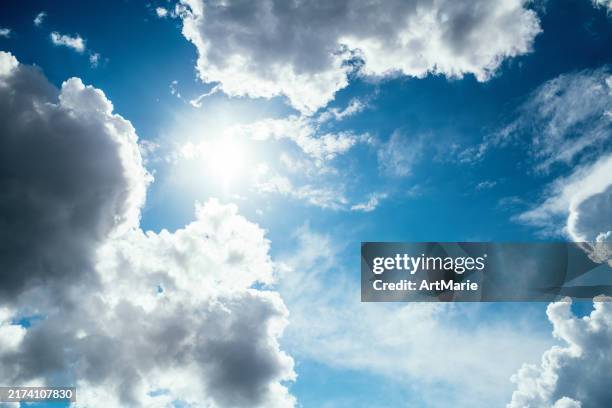clouds and sun in blue sky - nur himmel stock-fotos und bilder