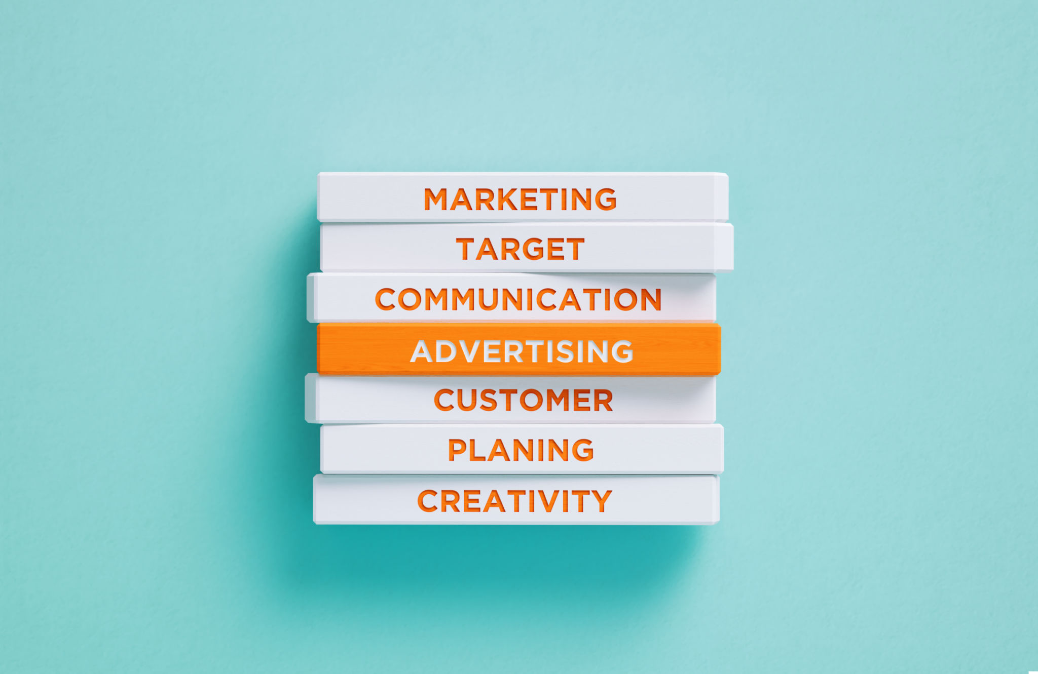 Advertising Related Words Written Wood Blocks On Blue Background - Advertising Concept Advertising Related Words Written Wood Blocks On Blue Background - Advertising Concept