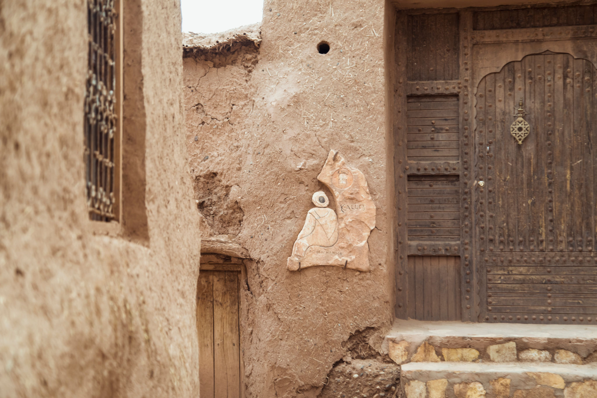 A Glimpse of Ancient Moroccan Architecture With Intricate Carvings and a Wooden Door in the Homeland A Glimpse of Ancient Moroccan Architecture With Intricate Carvings and a Wooden Door in the Homeland