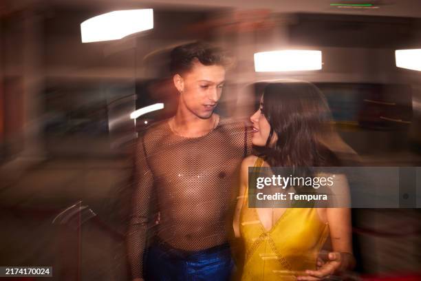 in the night, a young couple experiences haste and excitement as they walk the red carpet. - vip nightclub stock pictures, royalty-free photos & images