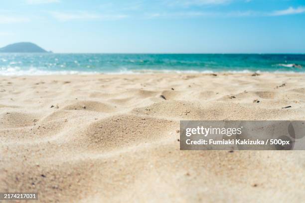 scenic view of beach against sky - zand stockfoto's en -beelden