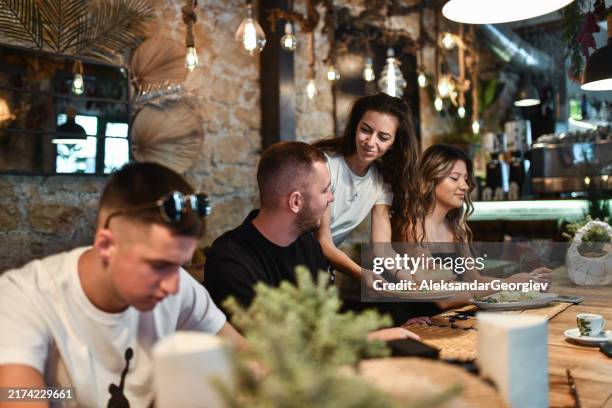 friends getting ready to eat while waitress brings dinner - ordering dinner stock pictures, royalty-free photos & images