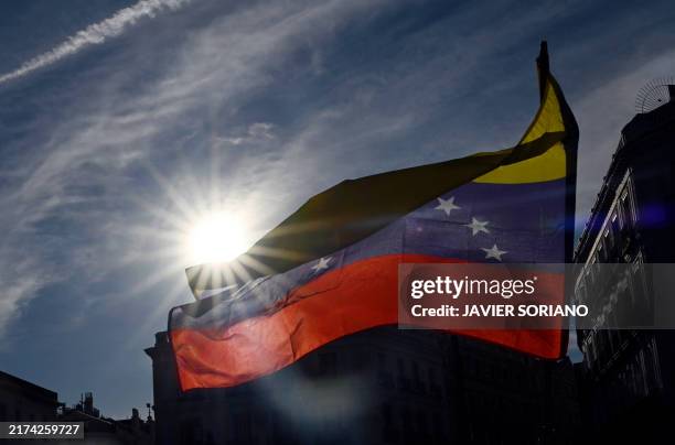Protesters wave Venezuelan flags during a demonstration after a call for global protests against the results of the disputed election in Venezuela,...