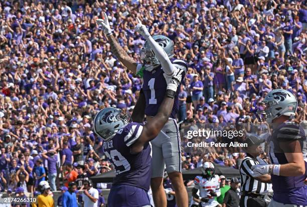 Wide receiver Jayce Brown of the Kansas State Wildcats celebrates with offensive lineman Taylor Poitier, after catching a touchdown pass against the...