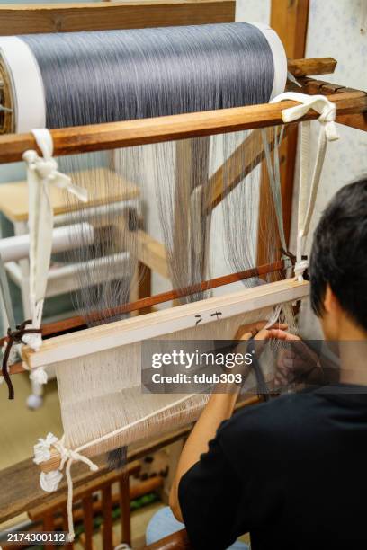 mid adult woman preparing to weave kimono fabric - loom stock pictures, royalty-free photos & images