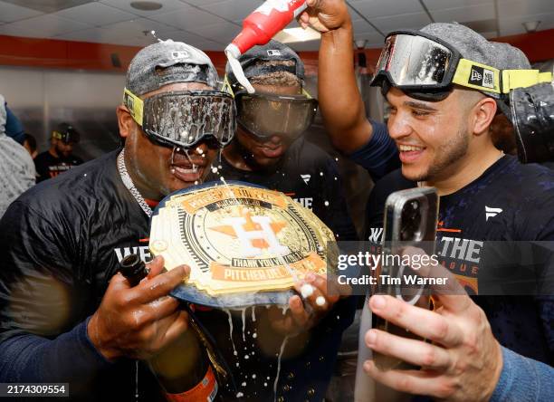The Houston Astros celebrate in the locker room after winning the AL West Division by defeating the Seattle Mariners at Minute Maid Park on September...