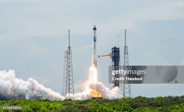 In this NASA handout, A SpaceX Falcon 9 rocket carrying the company's Dragon spacecraft is launched on NASA's SpaceX Crew-9 mission to the...