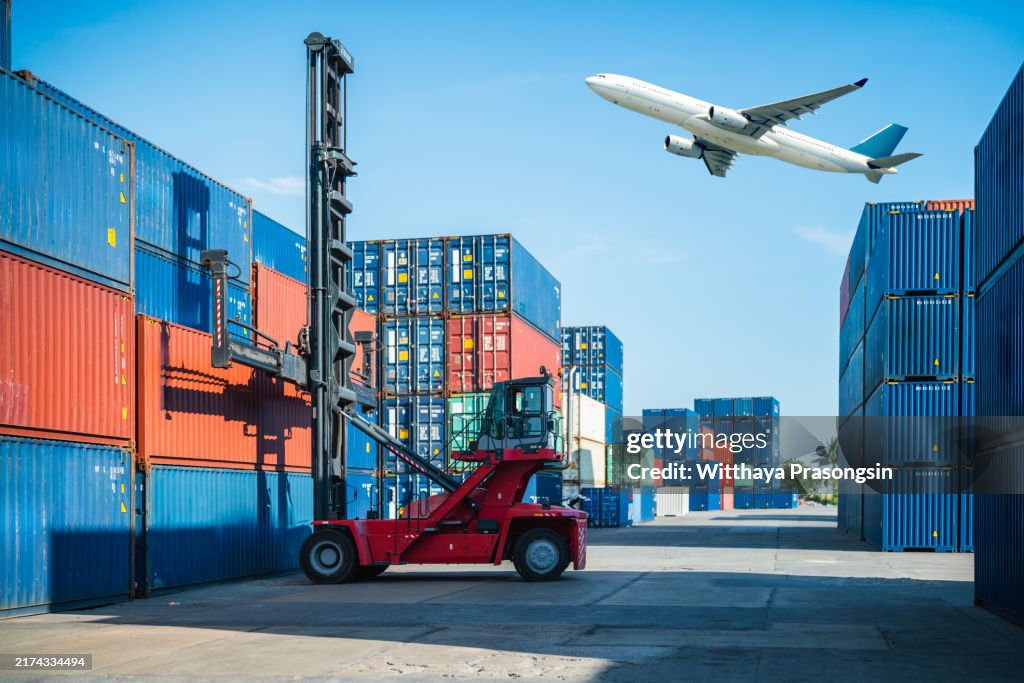 Air logistics. Cargo airplane flying above stack of logistic container.
