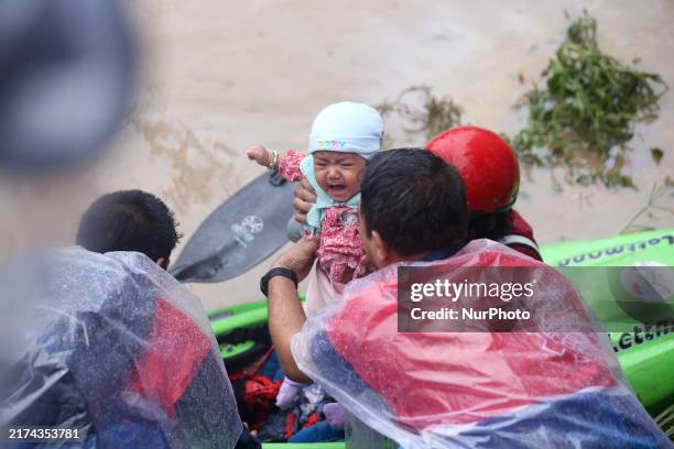 Nepal Army personnel evacuates an infant using a kayak from a flooded residential area in Kathmandu, Nepal, on September 28, 2024. At least 32 people...