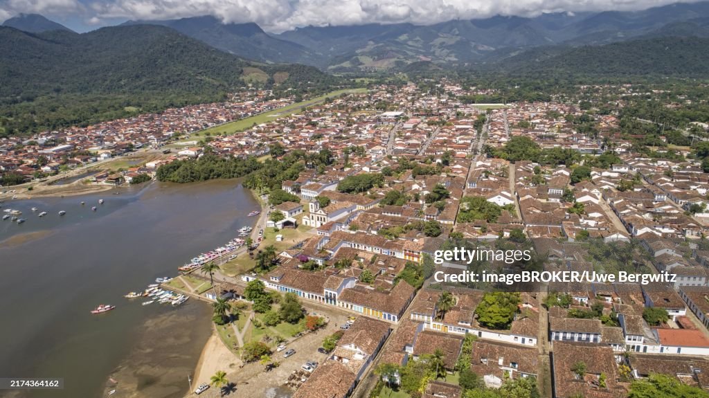 Aerial view to historic town Paraty and harbour, green mountains in background, sunny day, Unesco World Heritage, Brazil, South America