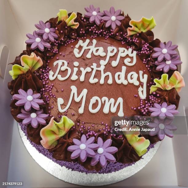 chocolate birthday and celebration cake with purple flowers, in a box, message on top - birthday cake message stock pictures, royalty-free photos & images