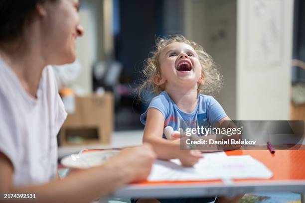 child development and learning. mom & daughter draw together. - nanny stock pictures, royalty-free photos & images