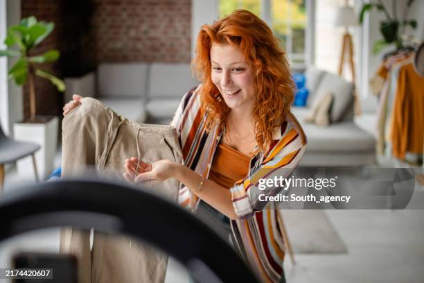 person presenting a tan item in a stylish living room - user generated content stock pictures, royalty-free photos & images