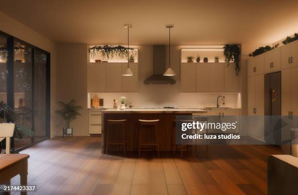 kitchen interior with island, cabinets, and pendant lights at night - plano geral imagens e fotografias de stock
