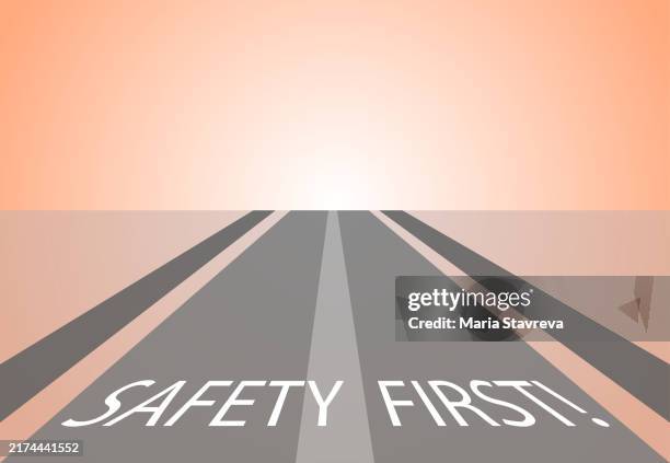 safety first written on road - safety first stock illustrations