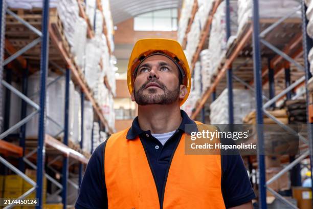 man working at a warehouse and looking at the merchandise - waistcoat stock pictures, royalty-free photos & images