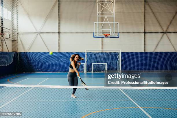 backhand stroke in tennis gameplay - tennis net stock pictures, royalty-free photos & images