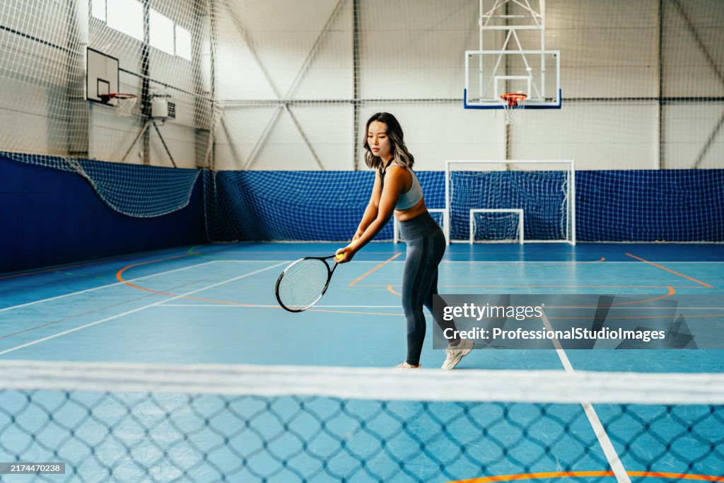 Focused female tennis player with racket