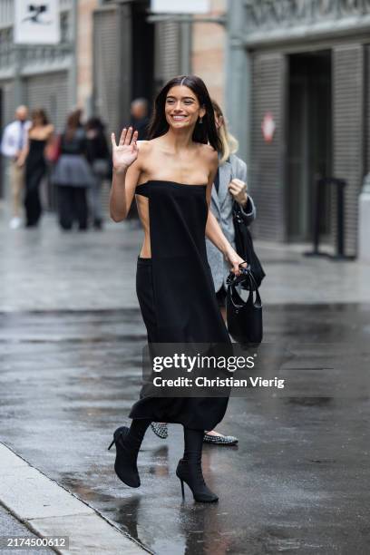American singer Dixie D'Amelio wears black off shoulder dress outside Courrèges during Womenswear Spring/Summer 2025 as part of Paris Fashion Week on...