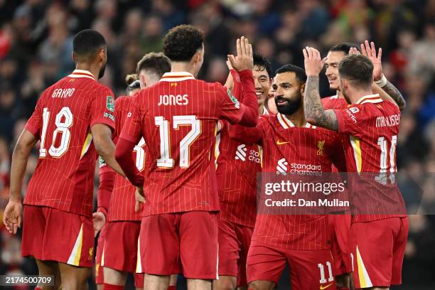 Mohamed Salah of Liverpool celebrates scoring his team's third goal with teammate Curtis Jones during the Carabao Cup Third Round match between...