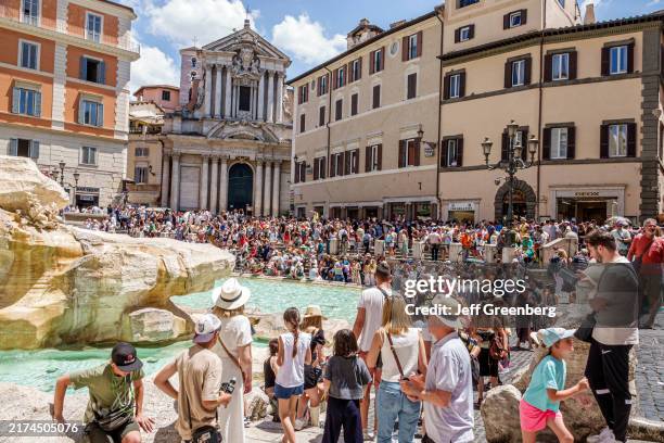 Rome, Italy, Piazza di Trevi, Trevi Fountain, Fontana di Trevi, Baroque design architect Nicola Salvi, large crowd of tourists with Church of Saint...