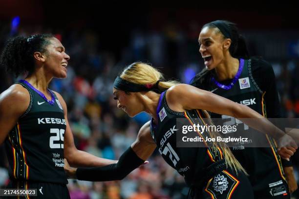 Alyssa Thomas, DiJonai Carrington and DeWanna Bonner of the Connecticut Sun react as they play the Indiana Fever during the fourth quarter of Game...