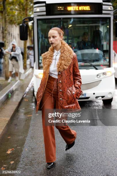 Marie Gaguech wears camel snake print leather jacket with brown fur collar, camel pants, white shirt, outside Rabanne, during Womenswear...