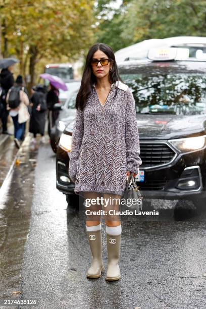 Mehrnaz Ansari wears lilac and brown knitted dress, olive green Chanel rain boots, grey Hermes bag, outside Rabanne, during Womenswear Spring/Summer...