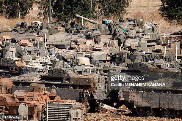 Israeli army tanks and armoured vehicles are deployed in the Upper Galilee region of northern Israel near the border with Lebanon on September 29,...
