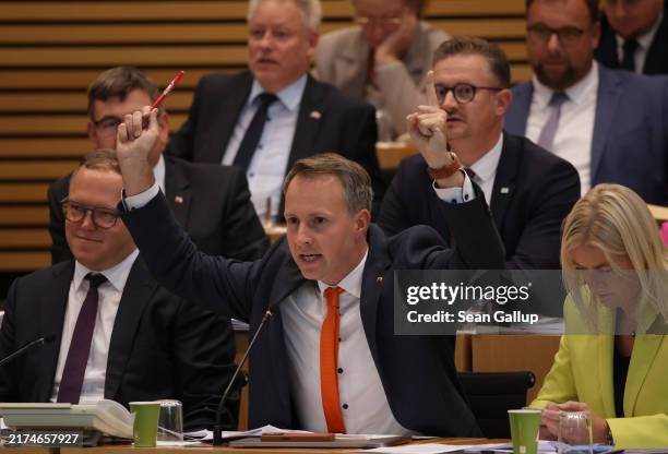 Andreas Buehl of the German Christian Democrats raises an objection during the inauguratory session of the Thuringia State Parliament following...