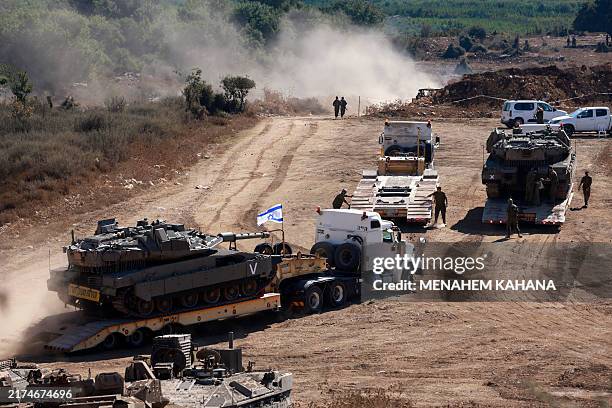 An Israeli tank is transported to a position in the Upper Galilee region of northern Israel near the border with Lebanon on September 29, 2024....