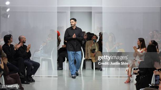 Designer Christopher Esber acknowledges audience on the runway during the Christopher Esber Womenswear Spring-Summer 2025 show as part of Paris...