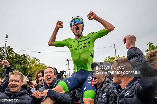 Slovenia's Tadej Pogacar celebrates with his team after winning the men's Elite Road Race cycling event during the UCI 2024 Road World Championships,...