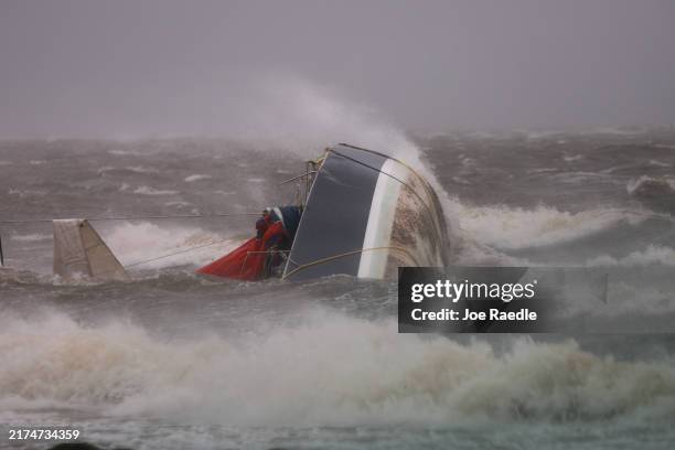 Capsized boat washes ashore as Hurricane Helene churns offshore on September 26, 2024 in St. Peteersburg Florida. Already a Category 3 storm, Helene...