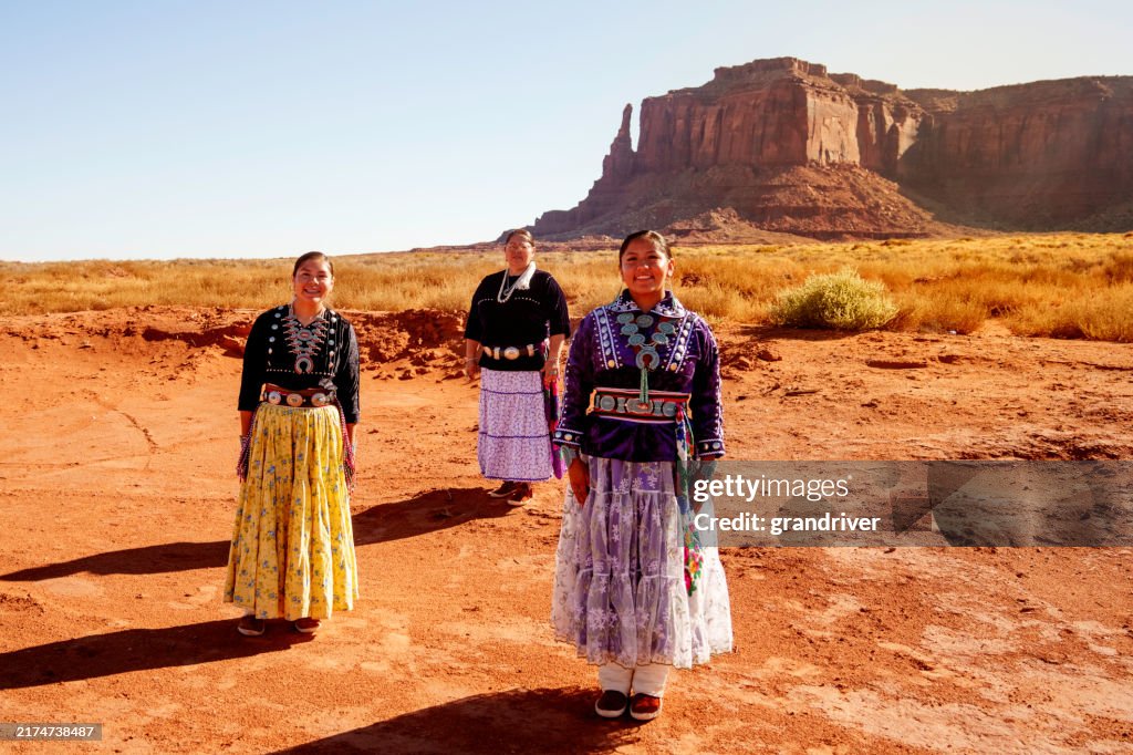 Navajo Mother and Two Daughters Portrait in Traditional Clothing in the Beautiful Desert Area of Monument Valley Utah