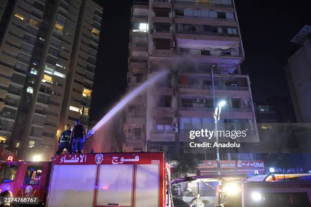 Firefighters extinguished the fire that broke out in the targeted apartment after the Israeli army carried out an airstrike on a multi-story building...