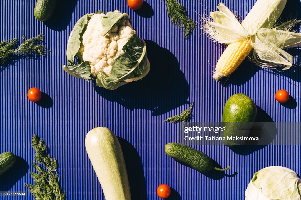 Different vegetables on a bright background, top view