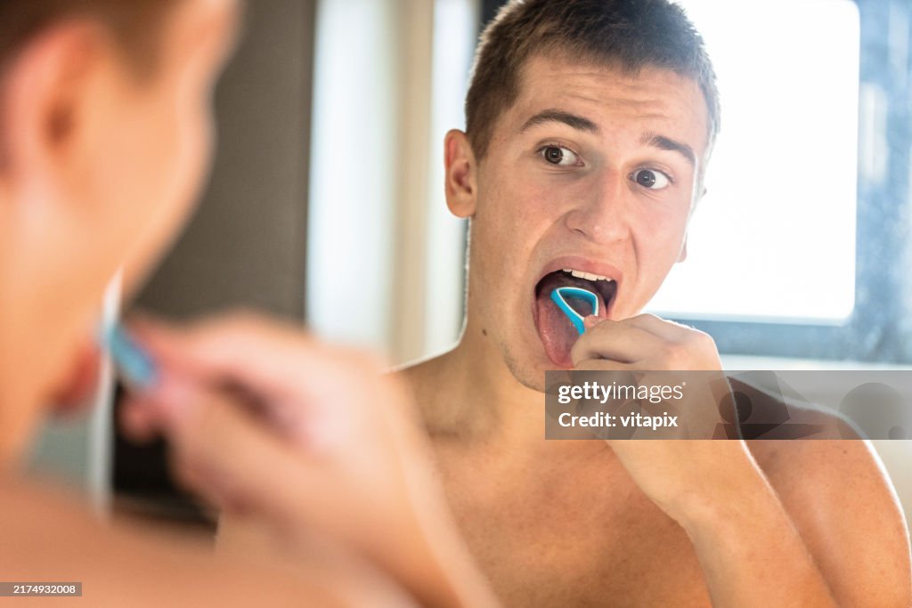 Man Using a Tongue Scraper