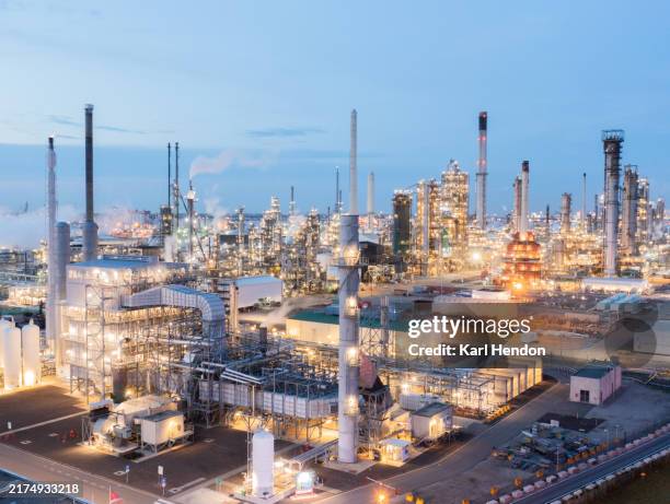 an aerial view of an industrial zone/ power station at night - centrale elettrica foto e immagini stock