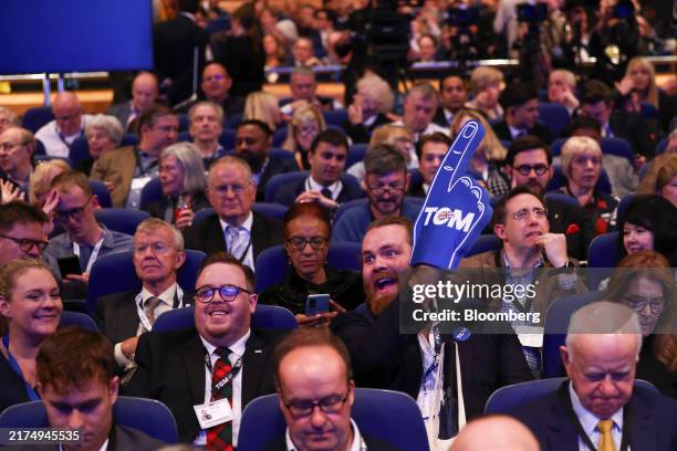 An attendee holds a foam finger with a slogan which reads "Tom" at the UK Conservative Party annual conference in Birmingham, UK, on Monday, Sept....