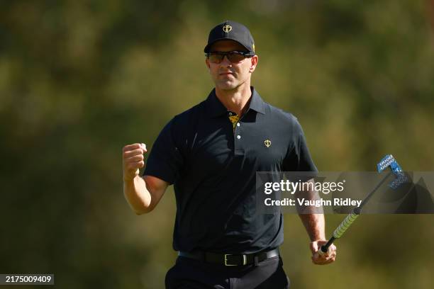 Adam Scott of Australia and the International Team celebrates after a putt on the fifth green during Friday Foursomes on day two of the 2024...